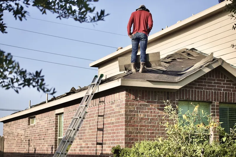 Professional roofer working on a residential roof in Robinson Ranch